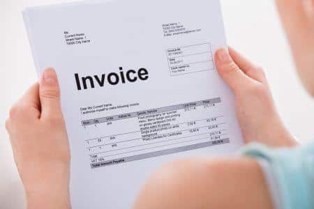 woman holding an invoice type document