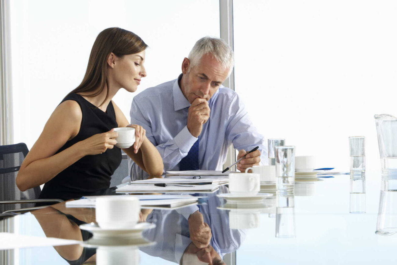two business workers sitting at office table